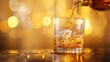 © Pravinrus - Close-up Pouring a whisky to glass, against a warm yellow background.