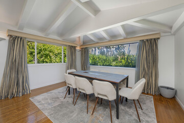 Wall Mural - Table surrounded by numerous white chairs, with a window beside it in Hidden Hills, CA