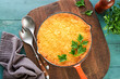 Shepherd's Pie with ground beef, peas, carrots, onions, potato and cheese on old wooden background in cast iron pan. Traditional British dish homemade casserole minced meat.Top view. Copy space.