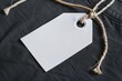 Blank Black Clothing Tag on Textured Fabric