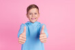 Photo of cheerful schoolchild hands fingers demonstrate thumb up empty space isolated on pink color background