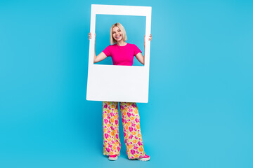 Sticker - Full body photo of attractive young woman hold instant photo frame dressed stylish pink clothes isolated on blue color background