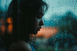 A beautiful girl with long black hair is standing by the window. She is looking outside at the rain. The rain is falling heavily and the girl is lost in thought.