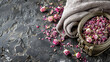 A bowl of pink petals sits on a black surface next to a towel. Concept of calm and relaxation, as the petals and towel suggest a spa or a place for self-care