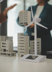 Poster - Close-up at tablet, Engineers pointing at tablet with their hands. To jointly design the use of renewable energy with wind and solar energy. Concept of using renewable energy.