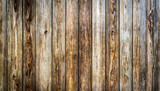 Fototapeta Desenie - Close-up of vertically arranged, aged wooden planks with a rich, weathered texture.
