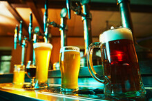 Several Glasses Of Divergent Beer Standing On Bar Counter. Enjoying Good Taste, Well-crafted Brew. Concept Of Beer Drink, Alcohol, Brewery, Pub Atmosphere, Taste