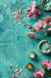 Spa setting with orchid flowers and body care and cosmetic tools on shabby chic turquoise background, top view, banner. Wellness concept