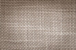 Hessian sackcloth jute burlap with woven cotton fabric cloth textile texture pattern background in brown beige aged color
