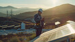Electrical Engineer Inspecting Solar Panel Site at Sunrise