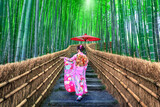 Fototapeta Zachód słońca - Bamboo Forest. Asian woman wearing japanese traditional kimono at Bamboo Forest in Kyoto, Japan.