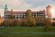 Krakow, Poland. 09.10.2022 Historical Wawel Castle and the Vistula River at dawn in autumn In the warm rays of the sun
