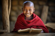 Young Masai boy smiling with book in traditional attire
