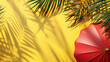 Tropical summer concept with palm leaves and a red umbrella on a yellow background