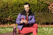 © Jorge Elizaquibel - Fitness woman sitting on a bench and texting on phone.