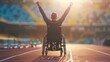 A man in a wheelchair is standing on a track and raising his arms in the air