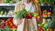 Senior woman buying fruits and vegetables at the market - Shopping food concept