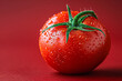 A vibrant tomato on a bold red background, showcasing the rich color and flavor of vine-ripened produce