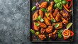 A tray holding crispy chicken wings with peppers, onions, and more, creating a flavorful and visually appealing dish