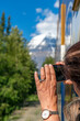 Woman taking photographs of Mount Robson peak from the Rocky Mountaineer train car, British Columbia, Canada.
