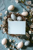 Fototapeta  - Nest with eggs and a card on a blue surface, perfect for Easter designs