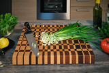 Fototapeta Desenie - Lots of chopped green onions on a beautiful wooden board.