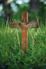 Poster - A wooden cross standing in a peaceful grassy field. Ideal for religious or spiritual concepts