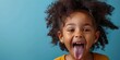 Spirited Young Girl Sticking Out Tongue in Playful Defiance Vibrant Blue Background