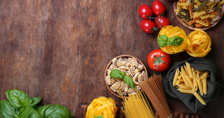 Wall Mural - italian food pasta basil cherry tomatoes on wooden table