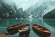 Three wooden boats on a peaceful lake with picturesque mountains