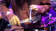 Close-up Of Man Playing Triangle Instrument At A Music Festival