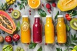 Top view of vibrant smoothies in bottles with tropical fruit and superfoods on concrete background Concept of clean eating and healthy breakfast
