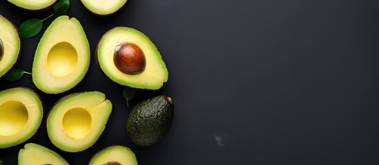 Wall Mural - Group of ripe avocados on dark surface