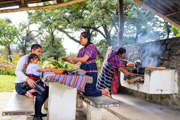 Canvas Print - The father and mother teach their little daughter how traditional foods from their region in Latin America are made.