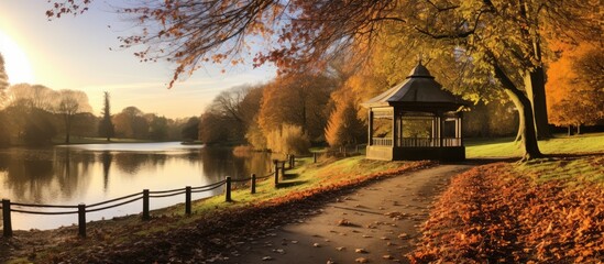 Canvas Print - Path by lake with gazebo in autumn