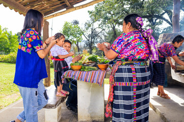Wall Mural - Everyone in the family makes small corn tamales with their hands, shares and learns.