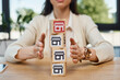A businesswoman sits at a table, engaging in a franchise concept, with a stack of blocks representing growth and innovation.