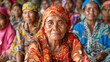 Women of East Timor Timor-Leste. Women of the World. An elderly woman in colorful traditional attire sits among a group of people with a thoughtful expression on her face.  #wotw