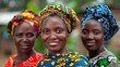 Women of Mozambique. Women of the World. Three African women smiling at the camera with colorful headscarves and traditional clothing against a blurred background.  #wotw
