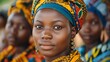 Women of Burkina faso. Women of the World. A confident young African woman in traditional attire with a group of people in the background.  #wotw