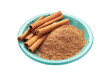 Cinnamon sticks and powder in blue plate isolated on white background.