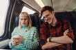 © Zamrznuti tonovi - A young couple is sitting in a train and talking during travel.