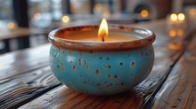   A Tight Shot Of A Candle In A Bowl On The Table Surrounding Background Features Candles Blurred Window In The Backdrop