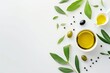 Top view of jug with olive oil olives and leaves on white background