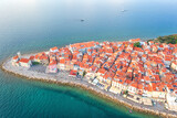 Fototapeta Do przedpokoju - Aerial view of Piran old town, Slovenia, beautiful landmark. Scenic cityscape with medieval architecture and red tiled roofs, famous tourist resort on Adriatic seacoast, outdoor travel background