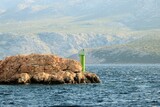 Fototapeta Na drzwi - green lighthouse by arriving the island Rab by ferry, Croatia