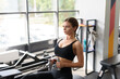 © Anton Pentegov - fit woman trains with a fitness equipment in fitness gym
