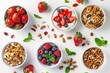 Healthy breakfast with muesli strawberries nuts and fruit on white background Top view