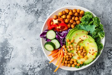 Wall Mural - Healthy vegan salad in white bowl with avocado chickpeas kale veggies top view