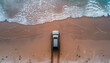 car rides on the sand of a sea beach, top view